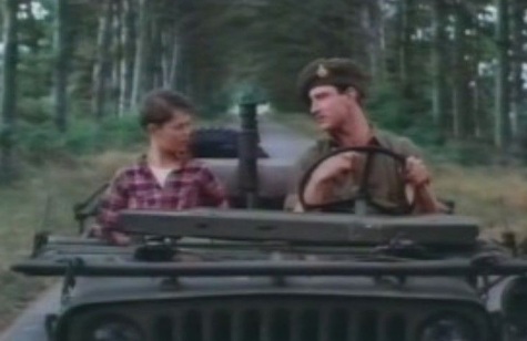 Boy and Soldier riding in Jeep